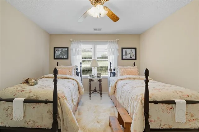 an aerial view of a house a yard and mountain view in back