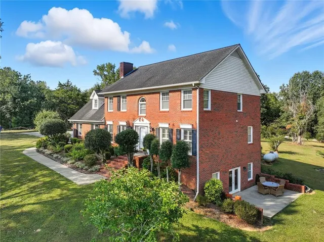 a front view of a house with garden