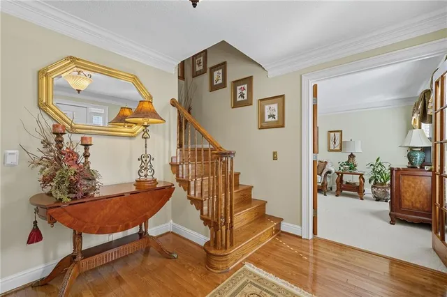 a living room with furniture a chandelier and a window