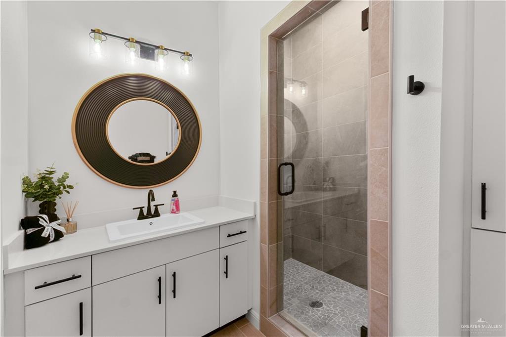 5321 Vision Street Rio Grande City, TX 78582 - Photo 14 of 34 a bathroom with a sink mirror vanity and shower