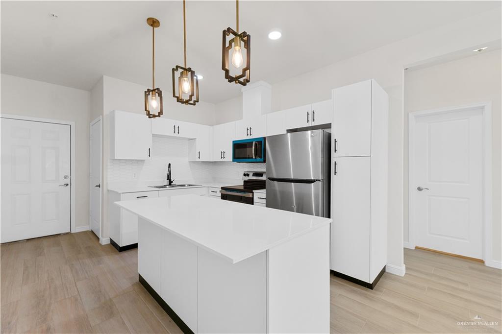 5321 Vision Street Rio Grande City, TX 78582 - Photo 15 of 34 a kitchen with a refrigerator a white stove top oven a sink and dishwasher