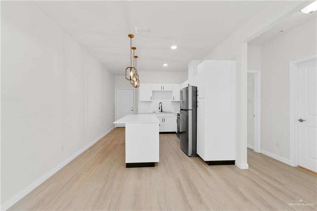 5321 Vision Street Rio Grande City, TX 78582 - Photo 16 of 34 an empty room with a kitchen and a sink