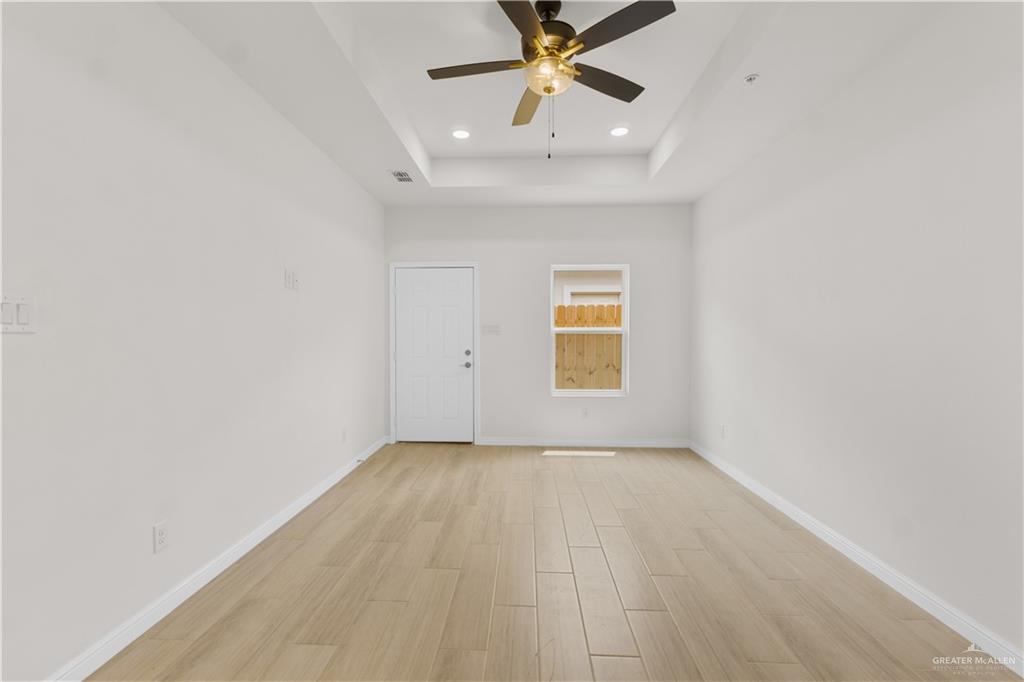 5321 Vision Street Rio Grande City, TX 78582 - Photo 17 of 34 an empty room with a window and a chandelier fan