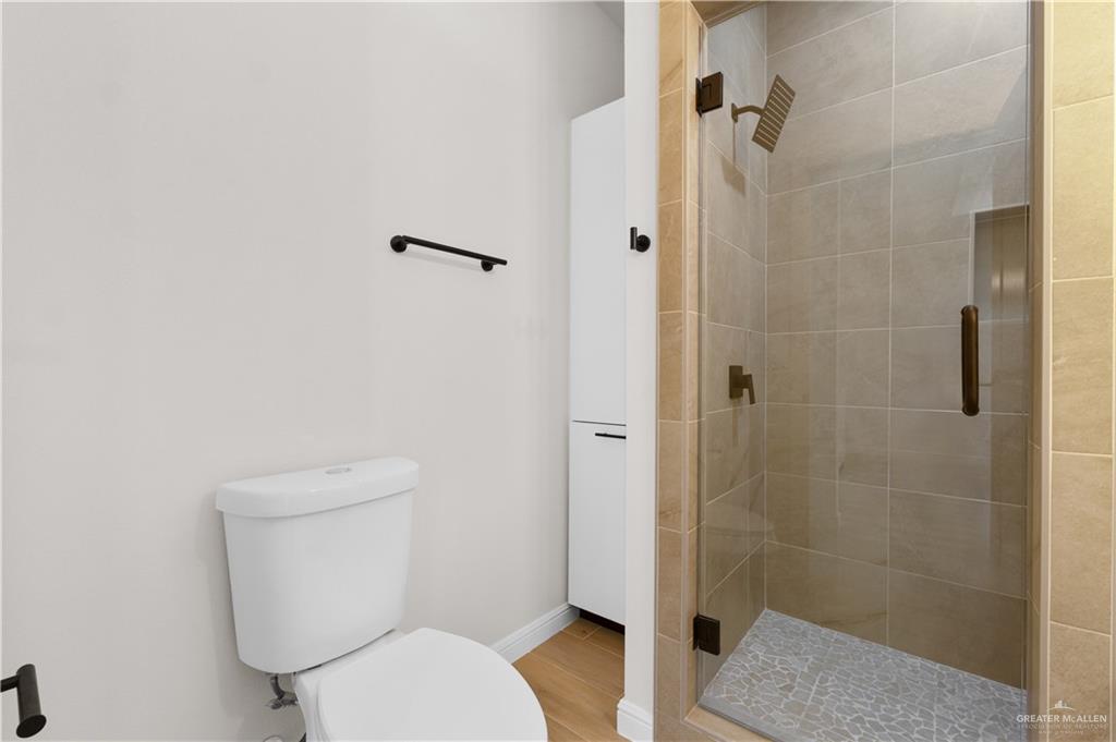 5321 Vision Street Rio Grande City, TX 78582 - Photo 18 of 34 a white toilet sitting next to a bathroom sink