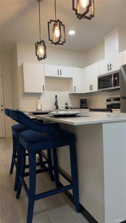 5321 Vision Street Rio Grande City, TX 78582 - Photo 28 of 34 a kitchen with a sink a cabinets and chairs