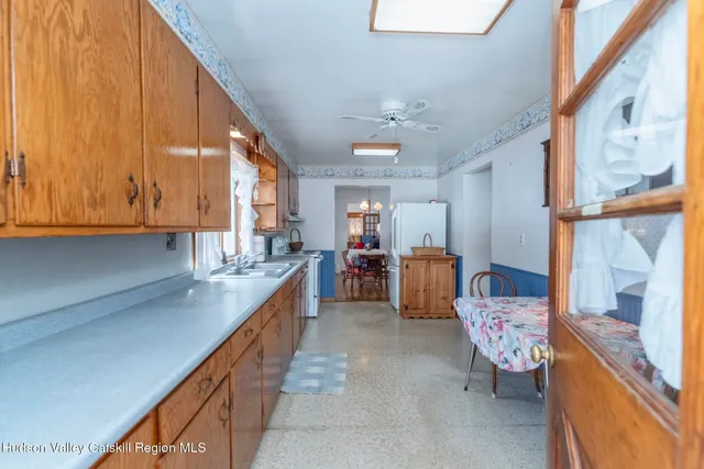 a kitchen with a sink a stove and cabinets