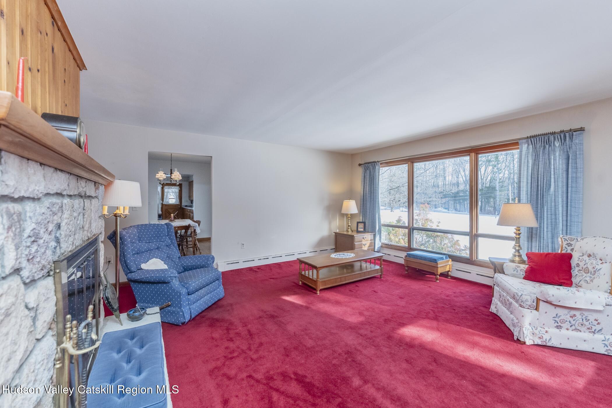 232 Cedar Hill Road High Falls, NY 12440 - Photo 17 of 42 a living room with furniture and a floor to ceiling window next to a ceiling window