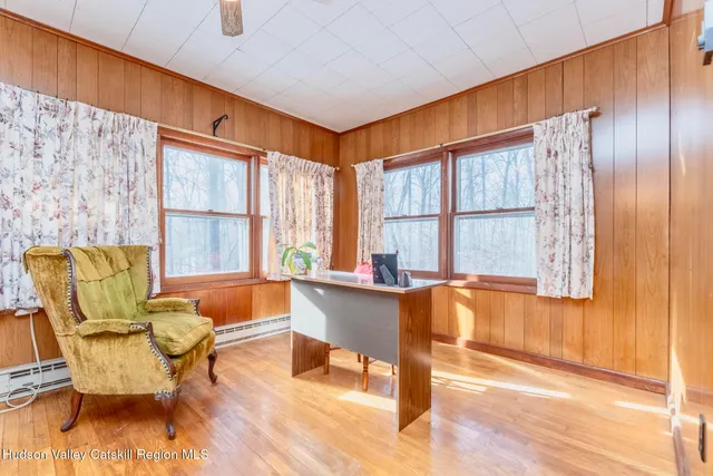 a view of a dining room with furniture window and wooden floor