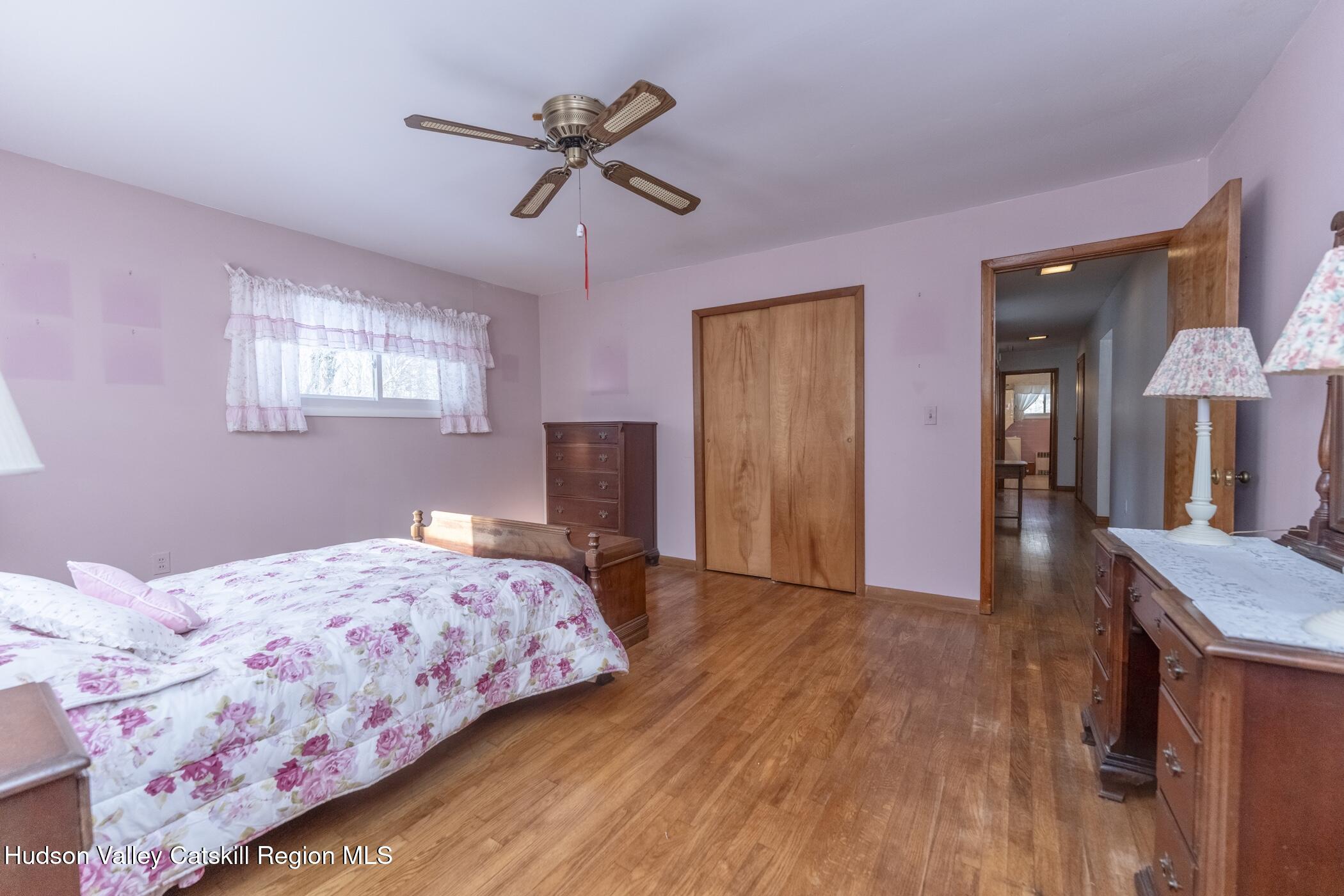 232 Cedar Hill Road High Falls, NY 12440 - Photo 25 of 42 a bedroom with a bed and a chandelier