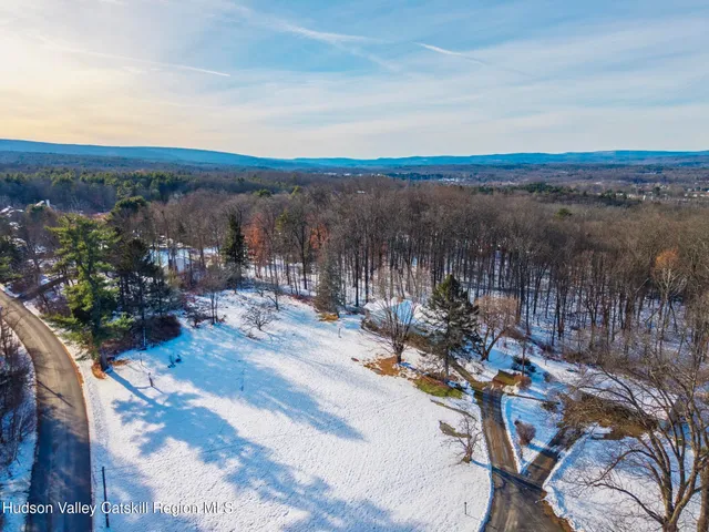 a front view of a house with a yard covered in snow