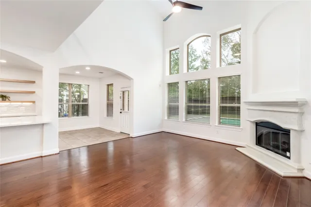 a view of a kitchen with wooden floor and a window