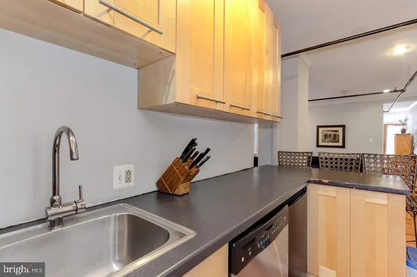 a kitchen with a sink a counter top space and cabinets