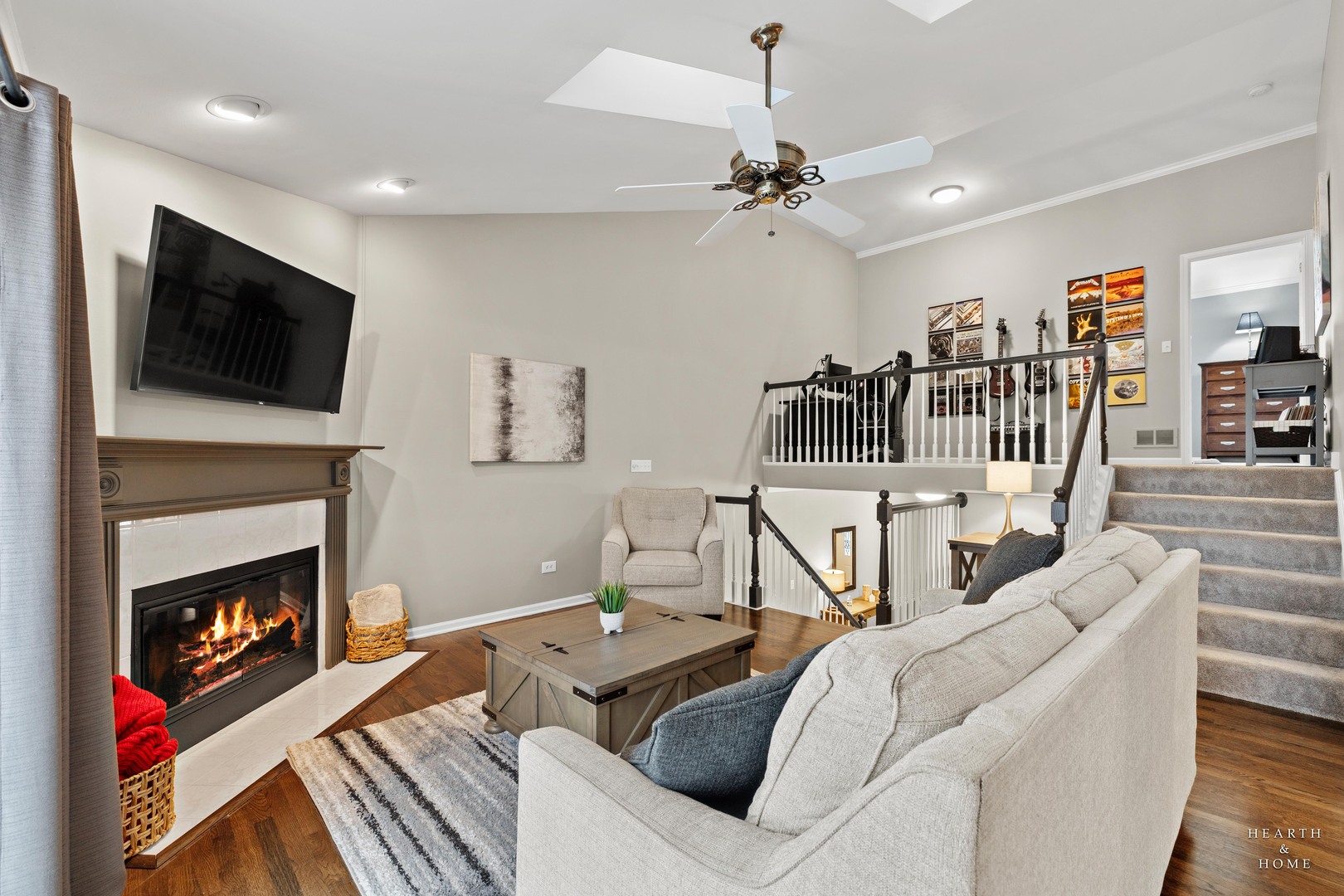 679 Barlina Road Crystal Lake, IL 60014 - Photo 12 of 28 a living room with furniture a flat screen tv and a fireplace