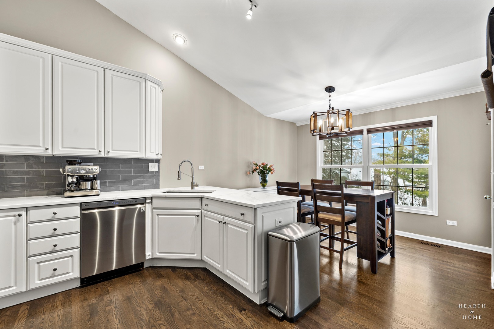 679 Barlina Road Crystal Lake, IL 60014 - Photo 7 of 28 a kitchen with a sink stove and white cabinets with wooden floor