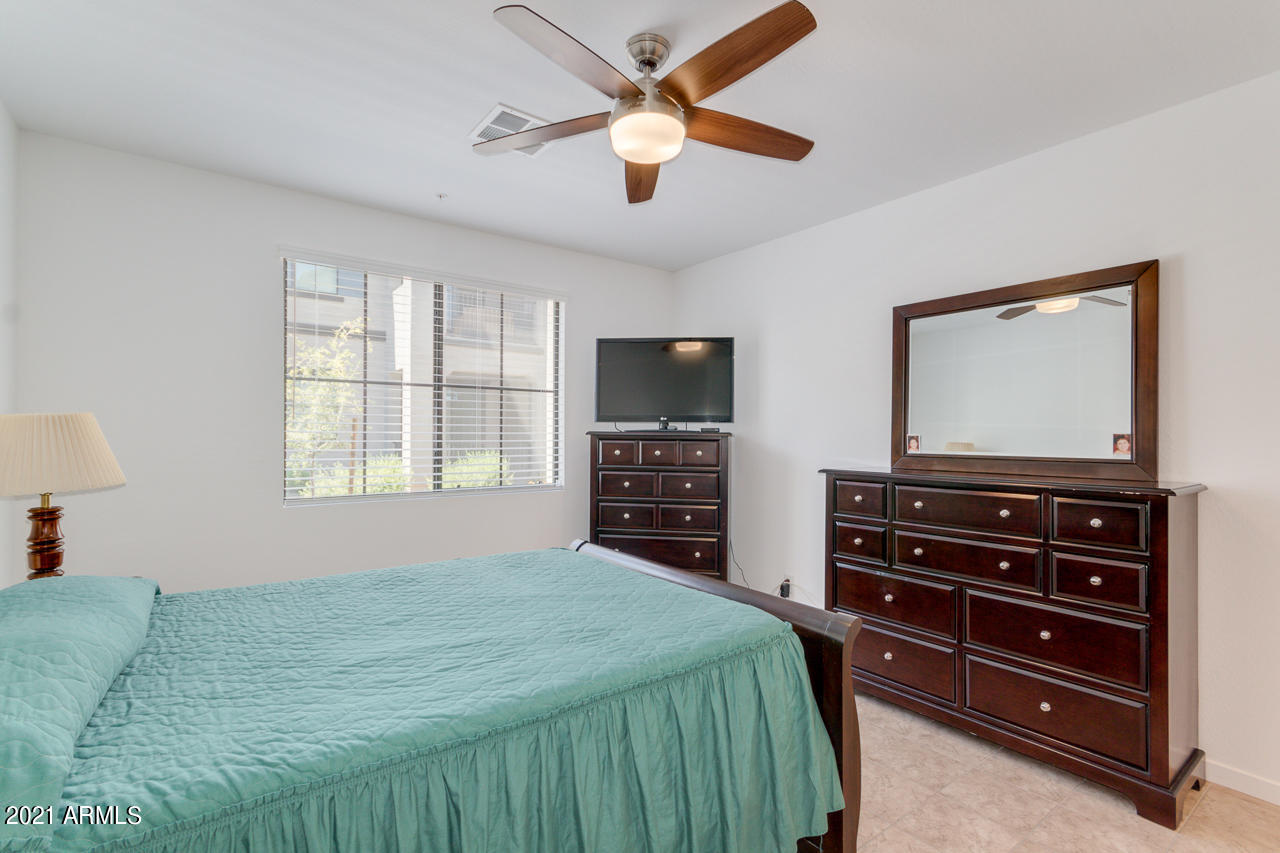 3900 East Baseline Road, Unit 135 Phoenix, AZ 85042 - Photo 11 of 19 a bedroom with a bed and a flat screen tv