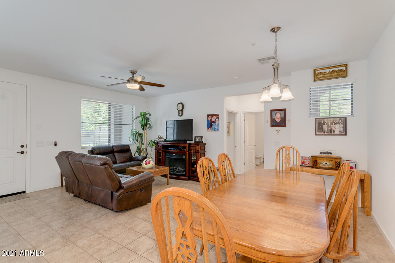 3900 East Baseline Road, Unit 135 Phoenix, AZ 85042 - Photo 5 of 19 a living room with furniture a chandelier and a window