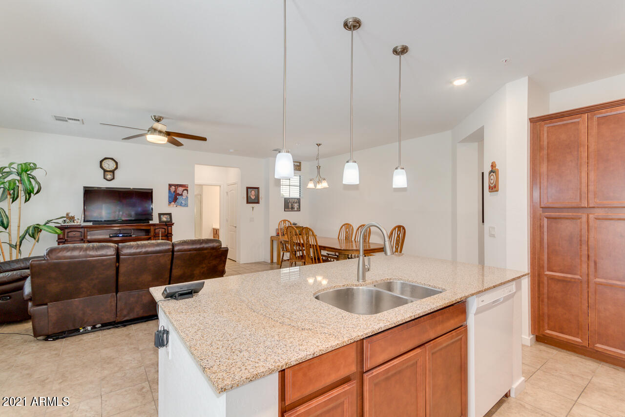 3900 East Baseline Road, Unit 135 Phoenix, AZ 85042 - Photo 9 of 19 a kitchen with kitchen island a sink counter space and stainless steel appliances