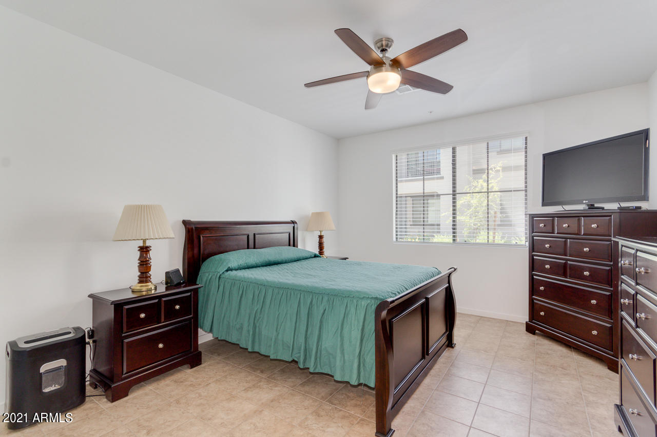 3900 East Baseline Road, Unit 135 Phoenix, AZ 85042 - Photo 10 of 19 a bedroom with a bed and a tv