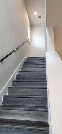 a view of hallway with wooden floor