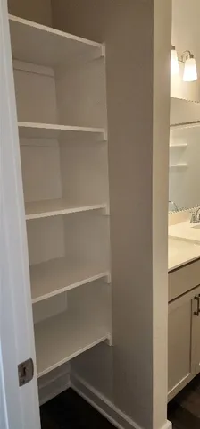 a view of walk in closet with empty racks