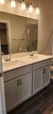 a bathroom with a sink vanity granite and a mirror