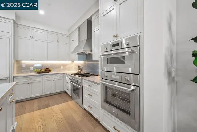 a kitchen with granite countertop stainless steel appliances and wooden cabinets