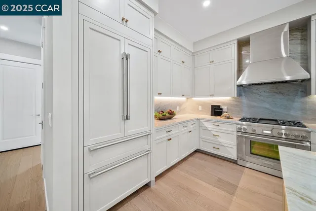 a kitchen with white cabinets and white appliances