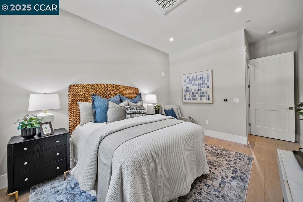 600 Hartz Avenue, Unit 103 Danville, CA 94526 - Photo 19 of 34 a bedroom with a bed and a lamp on dresser