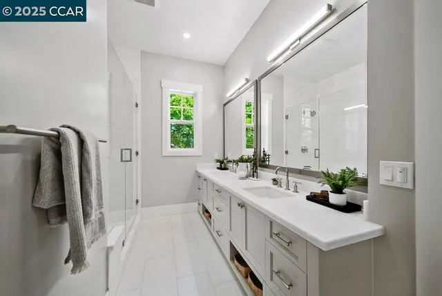 a bathroom with a double vanity sink and mirror