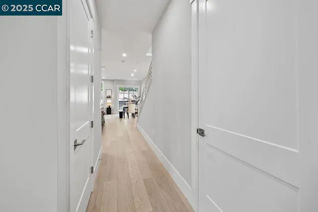 a view of a hallway with wooden floor