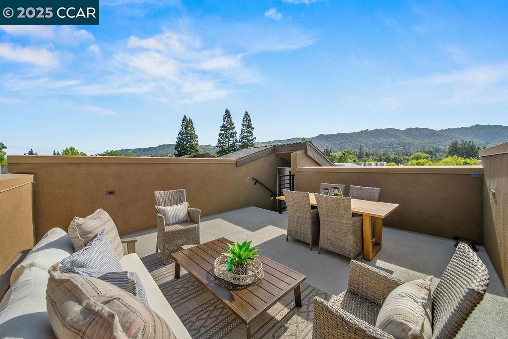 600 Hartz Avenue, Unit 103 Danville, CA 94526 - Photo 31 of 34 a view of a balcony with furniture and a potted plant
