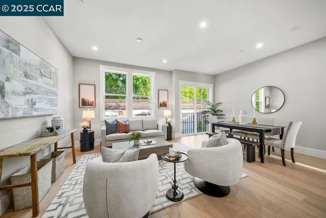 a living room with fireplace furniture and a large window