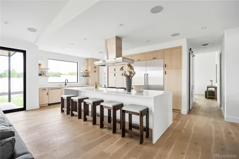 a large kitchen with a table and chairs