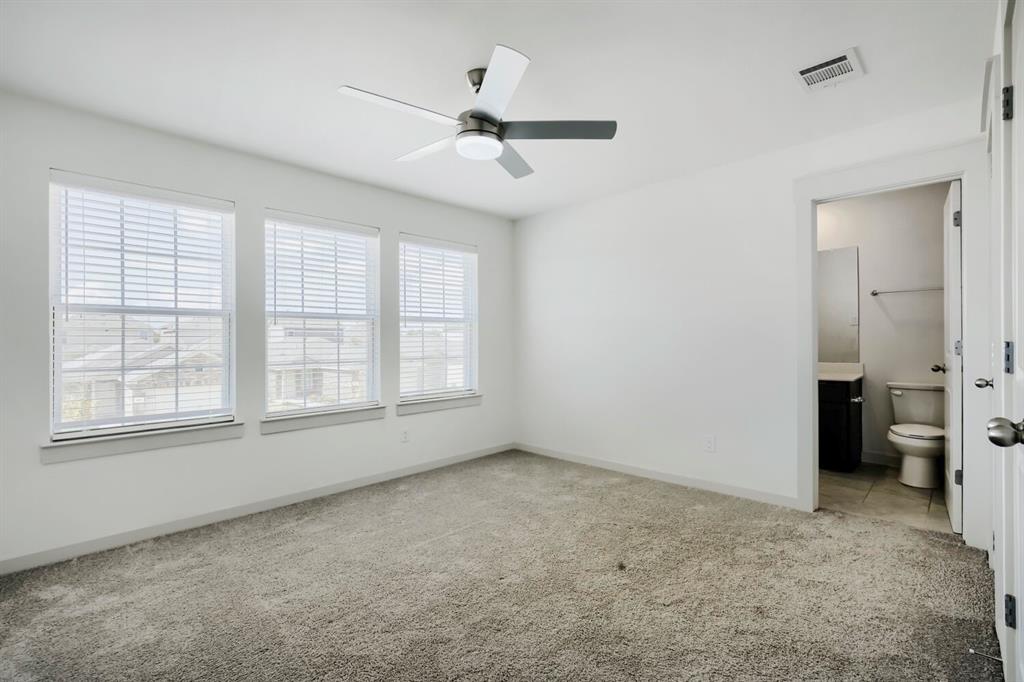 1368 Cedar Street Forney, TX 75126 - Photo 19 of 29 Bright room with three windows featuring blinds, a ceiling fan with integrated lighting, and carpeted flooring