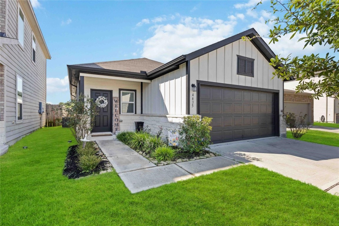 a front view of a house with a yard and garage