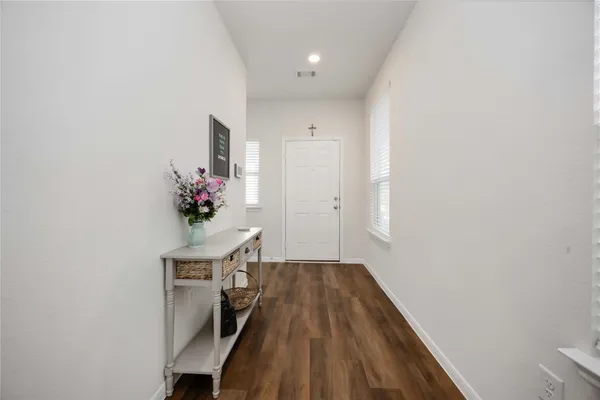 a workspace with wooden floor and a potted plant