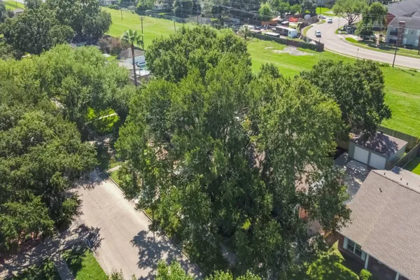 an aerial view of a house with outdoor space and lake view