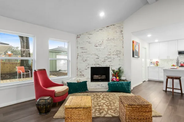 a living room with furniture a flat screen tv and a fireplace