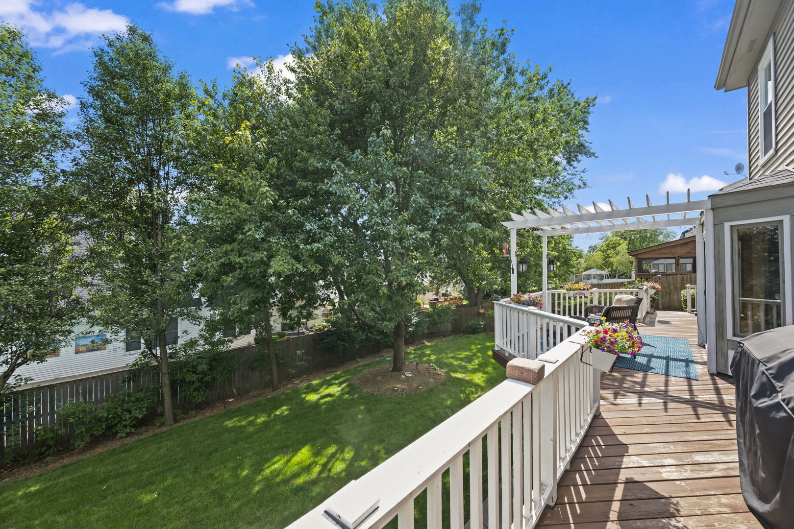 1565 Freeman Road Hoffman Estates, IL 60192 - Photo 6 of 46 a view of a deck with couches and wooden floor next to a yard