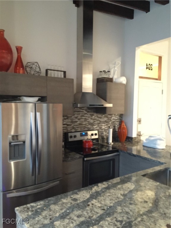 2278 First Street, Unit 204 Fort Myers, FL 33901 - Photo 17 of 24 a kitchen with stainless steel appliances granite countertop a refrigerator and a stove
