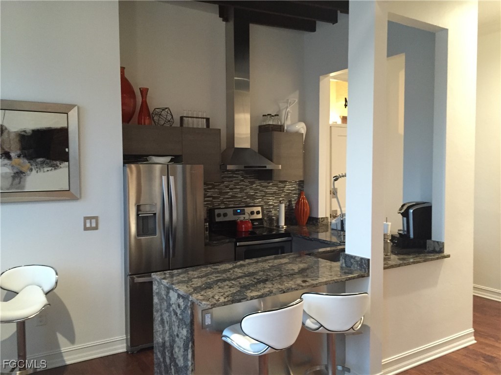 2278 First Street, Unit 204 Fort Myers, FL 33901 - Photo 18 of 24 a kitchen with a table and chairs in it