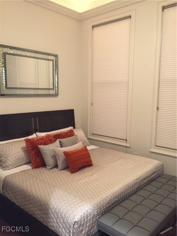 2278 First Street, Unit 204 Fort Myers, FL 33901 - Photo 19 of 24 a bedroom with a bed and a window