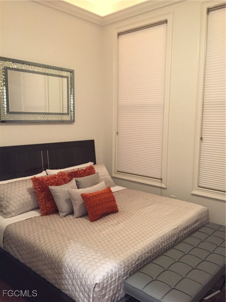 2278 First Street, Unit 204 Fort Myers, FL 33901 - Photo 19 of 24 a bedroom with a bed and a window