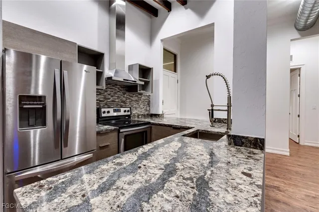 a kitchen with stainless steel appliances granite countertop a stove and a refrigerator