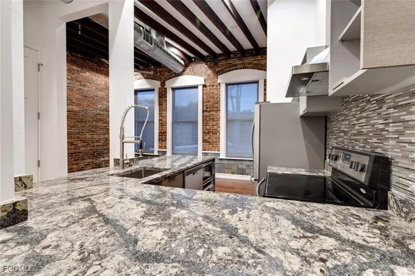 a kitchen with stainless steel appliances granite countertop a stove and a refrigerator