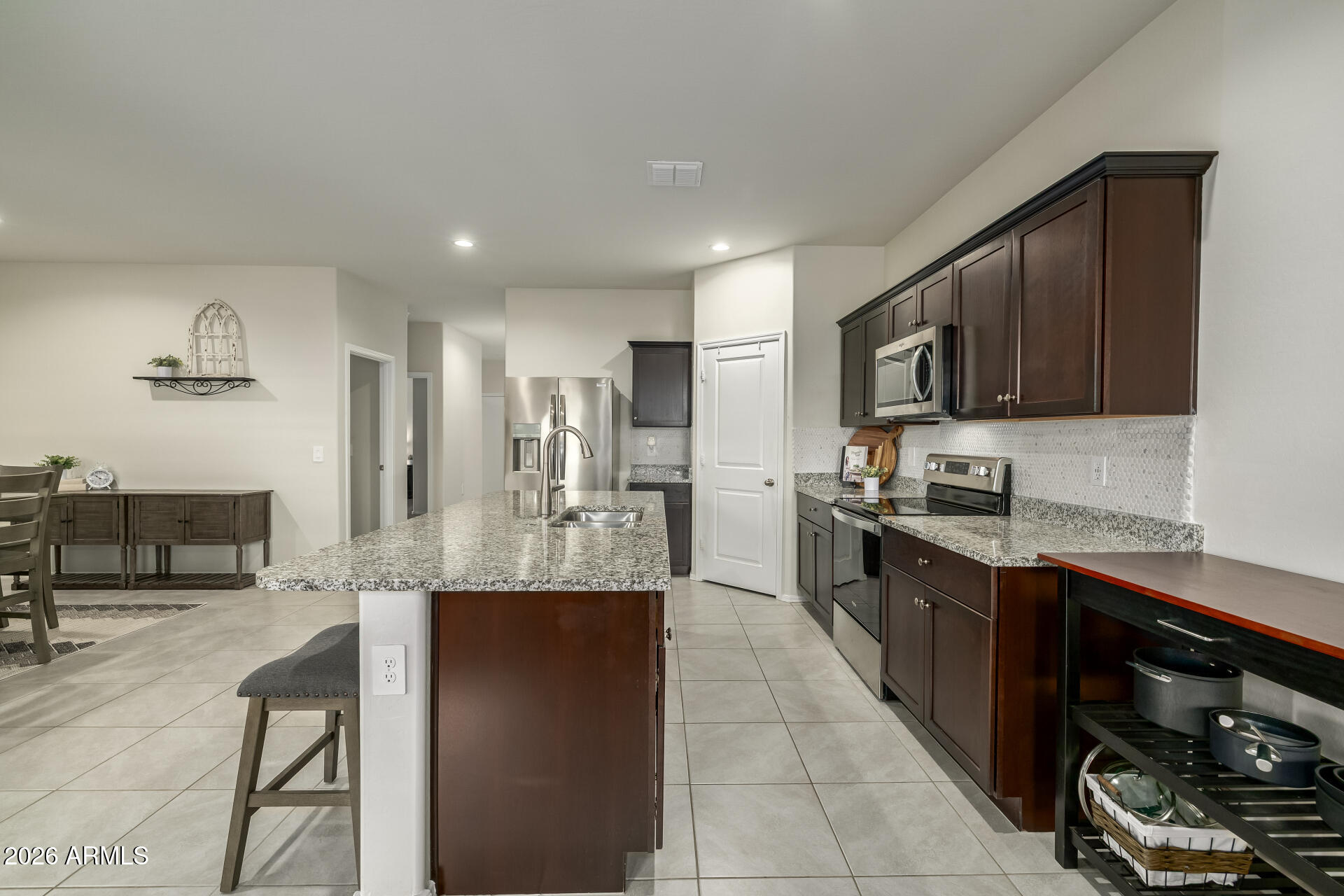 9471 Greenhouse Road Florence, AZ 85132 - Photo 6 of 22 a large kitchen with stainless steel appliances lots of counter top space cabinets and a stove top oven
