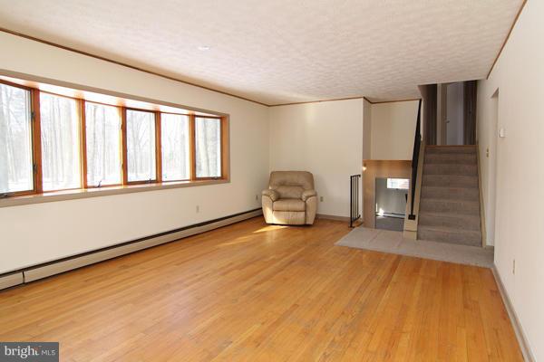 21601 Gunpowder Road Manchester, MD 21102 - Photo 12 of 30 a view of an empty room with a window and wooden floor