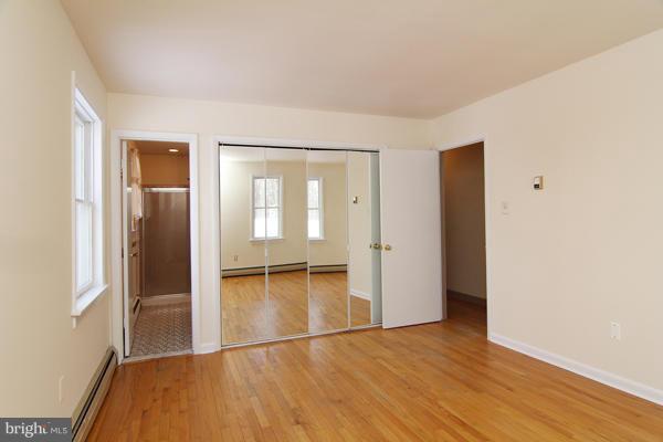 21601 Gunpowder Road Manchester, MD 21102 - Photo 22 of 30 an empty room with wooden floor and a bathroom