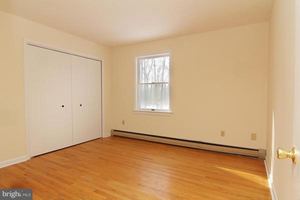 21601 Gunpowder Road Manchester, MD 21102 - Photo 24 of 30 a view of an empty room with wooden floor and a window