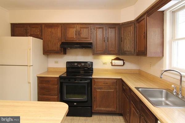21601 Gunpowder Road Manchester, MD 21102 - Photo 4 of 30 a kitchen with a sink a stove and refrigerator